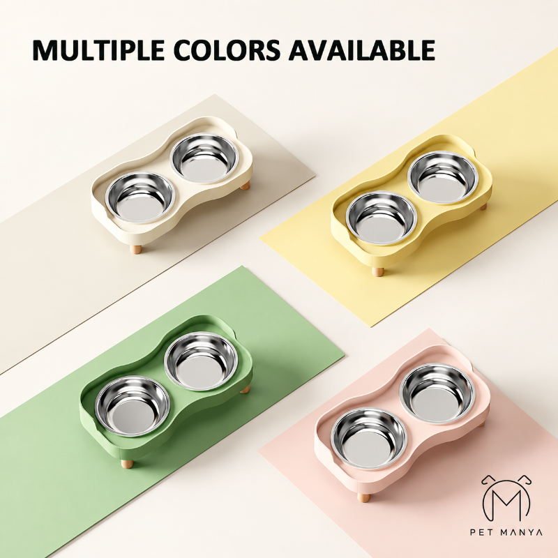 Four pet double bowls shown in different colors: cream, pale yellow, mint green, and blush pink, each with stainless steel bowls and small wooden feet. The text 'MULTIPLE COLORS AVAILABLE' appears at the top, and the brand name 'PET MANYA' is shown at the bottom right.