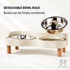 A beige detachable pet feeder stand with two stainless steel bowls and wooden legs, shown on a clean white background with text reading 'DETACHABLE BOWL RACK' and 'Bowls can be freely combined.' A second floating bowl is displayed above the stand.