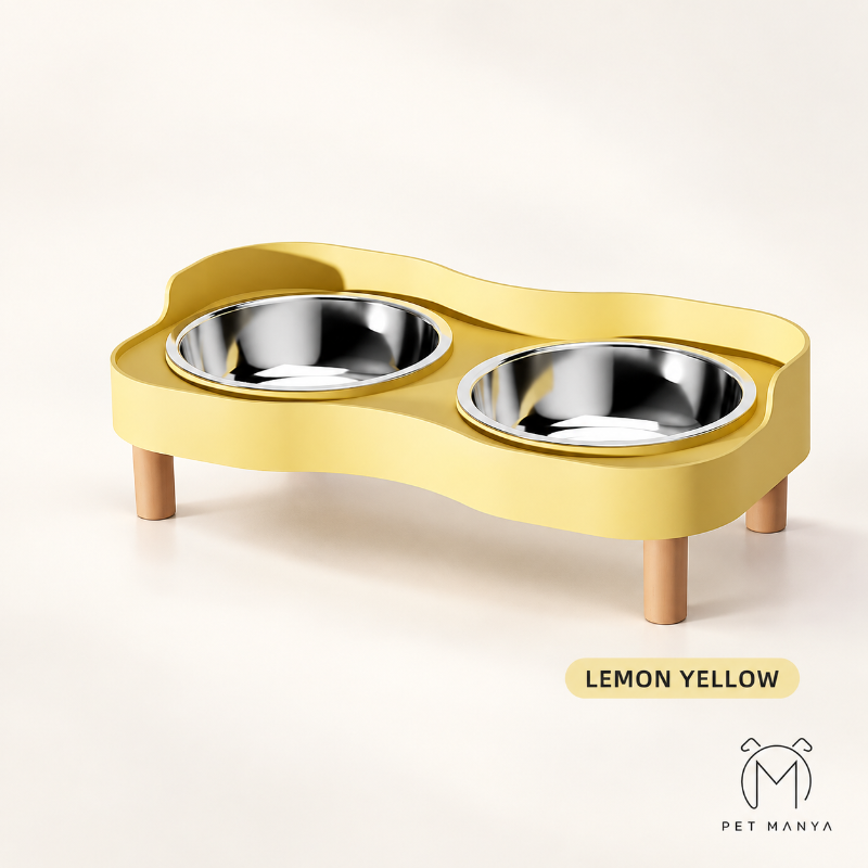A pet elevated feeding station in lemon yellow with two stainless steel bowls, shown on a clean off-white background with a 'LEMON YELLOW' label and the 'PET MANYA' brand logo.
