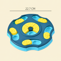 A blue and yellow pet puzzle toy shown on a light beige background with a dimension line indicating 22.7 cm width.