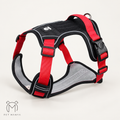A red and black dog harness with gray mesh padding, shown on a light beige background. The brand logo 'Pet Manya' is visible in the bottom-left corner.