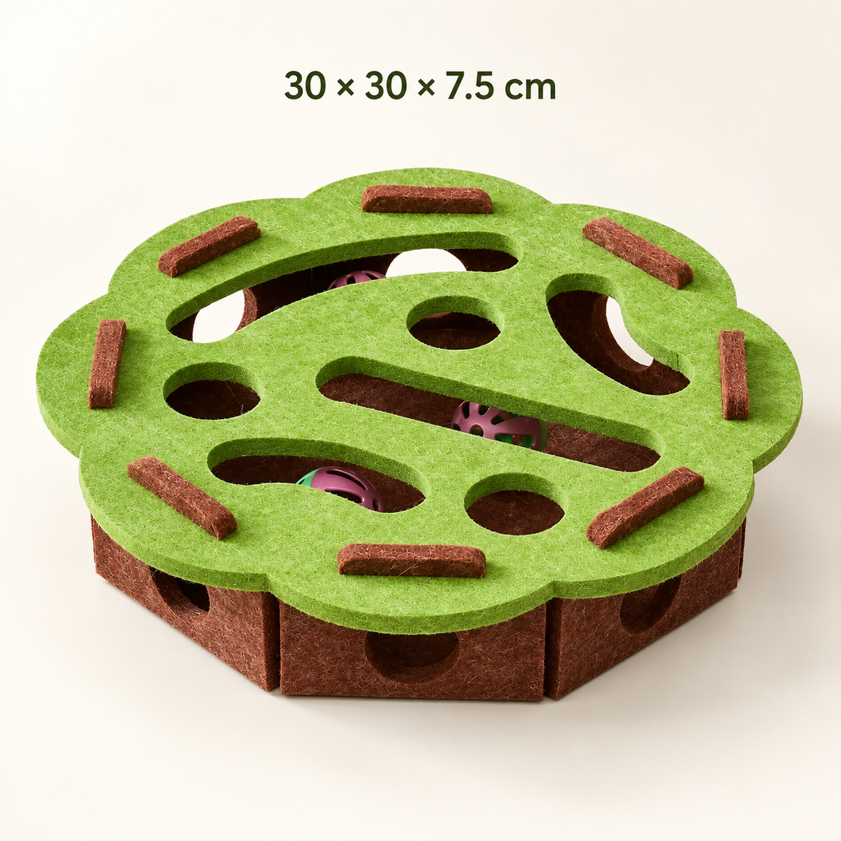 A felt cat toy with a green top and brown base, featuring circular cutouts, textured brown bars, and visible pink and purple balls inside. Text at the top reads '30 x 30 x 7.