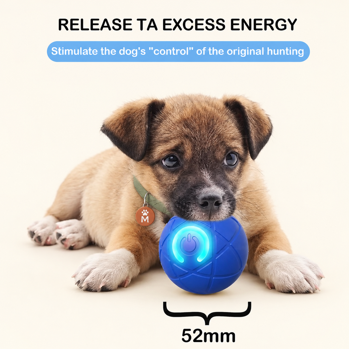A small brown puppy lies on a light cream background holding a blue textured ball toy with a glowing blue ring. Text at the top reads 'RELEASE TA EXCESS ENERGY' and 'Stimulate the dog's "control" of the original hunting,' with a size marker below the toy reading '52mm.