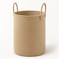 A cylindrical woven rope storage basket in a natural tan color, featuring two loop handles on the sides, set against a plain white background.